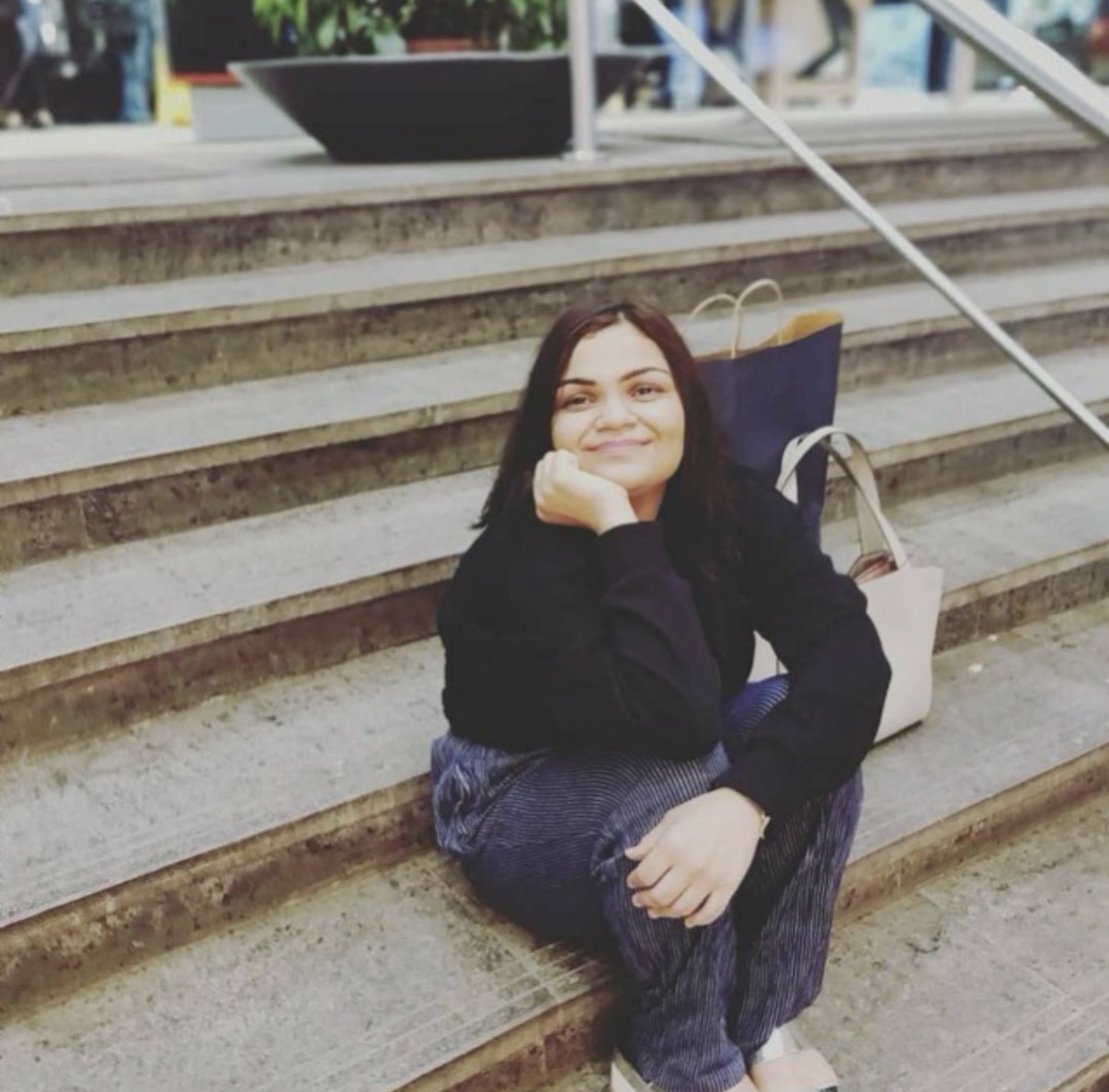 Vinita Mathreja, AI writer and founder of WhatTheWeb, seated on steps in Mumbai